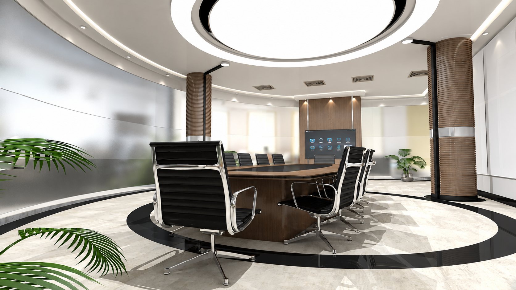 Salle de réunion contemporaine avec une grande table ovale en bois, des fauteuils noirs à structure chromée, un écran mural et des plantes vertes sous un plafonnier circulaire lumineux.